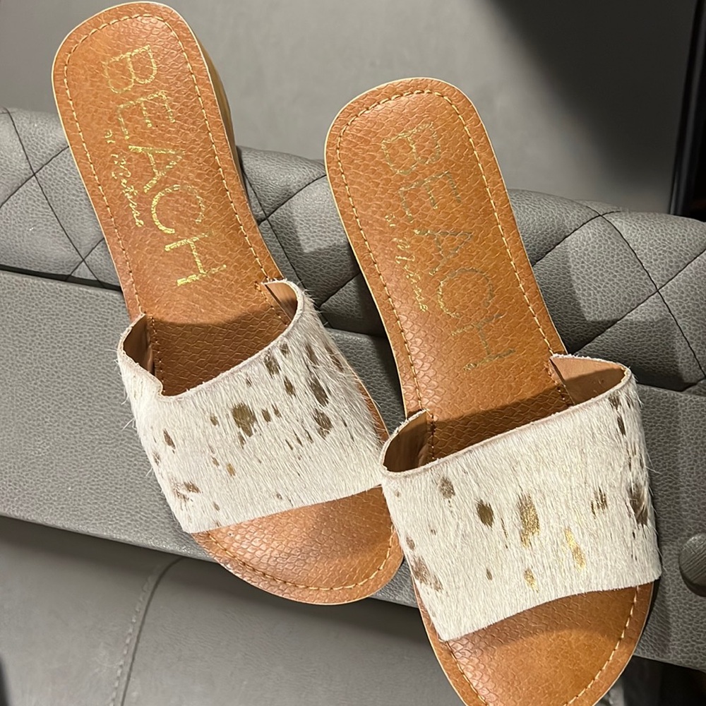 Cowhide, leather with gold accent.